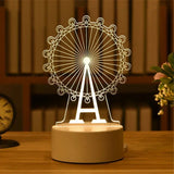 Acrylic night light with etched ferris wheel design on a lit base
