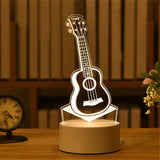 Acrylic night light etched with an acoustic guitar design glowing on a base