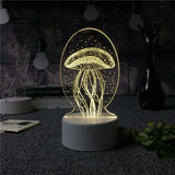 Acrylic LED lamp with etched jellyfish design glowing on a white base