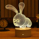 Acrylic night light etched with a rabbit design on a lit wooden base