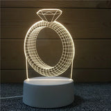 Acrylic night light etched with a diamond ring design on a lit base