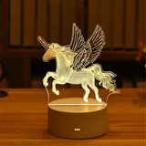 Acrylic LED lamp with etched winged unicorn design on a wooden base