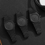 Close-up of the black matte steel watch case, crown, and pushers