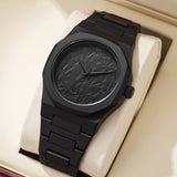 Black matte steel octagonal watch with Arabic numeral dial shown front facing on a stand