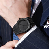 Black octagonal watch worn on wrist with a pinstripe suit sleeve