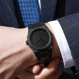 Black octagonal watch worn on wrist with a white dress shirt cuff