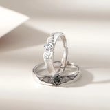 Silver angel and demon couple rings shown at a close angled detail