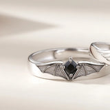 Silver angel and demon couple rings shown from a side angle