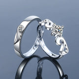 Silver angel and demon couple rings displayed on a blue background