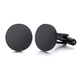 Pair of matte black round cufflinks with domed faces on white background
