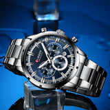 Silver steel watch with blue dial shown at an angle on a deep blue background