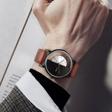 Wrist wearing black case watch with half hollow dial and dark strap