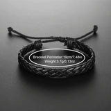 Black braided leather bracelet shown close up on a dark background