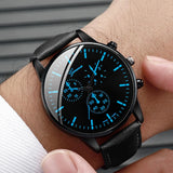 Black chronograph watch with blue accents worn on wrist
