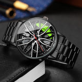 Black car wheel style watch with green caliper accent resting on a dark textured surface