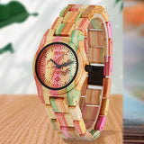 Colorful bamboo wood watch case shown close up with foliage in the background