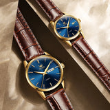 Gold blue dial couple watches with brown leather straps displayed together