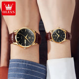 Two wrists side by side each wearing a matching gold black dial leather watch