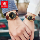 Two wrists clasped together each wearing a gold black dial brown leather watch