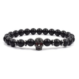 Black matte onyx bead bracelet with black tone crown charm