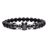 Black matte onyx bead bracelet with double black tone crown charms