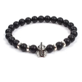 Black matte onyx bead bracelet with black tone skull charm