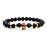 Black matte onyx bead bracelet with gold crown charm and gold bead accents