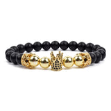 Black matte onyx bead bracelet with double gold lion head charms