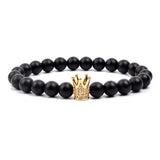 Black matte onyx bead bracelet with small gold tone crown charm