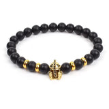 Black matte onyx bead bracelet with small gold skull charm and gold bead accents