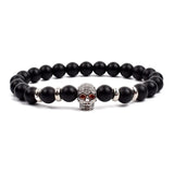 Black matte onyx bead bracelet with tiny gold tone crown charm