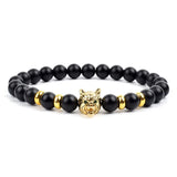 Black matte onyx bead bracelet with gold wolf head charm and gold bead accents