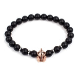 Black matte onyx bead bracelet with rose gold skull charm