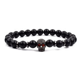 Black matte onyx bead bracelet with small rose gold toned charm