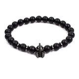 Black matte onyx bead bracelet with small white gold tone crown charm