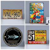 Four finished metal tin signs with vintage licence plate, comic and warning sign designs