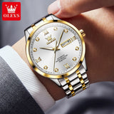 Close-up of the two-tone silver and gold watch with white dial worn on wrist