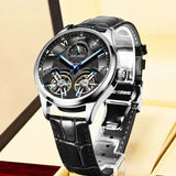 Silver case automatic watch with black skeleton dial, twin flywheels and black leather strap