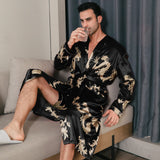 Man wearing a black silk robe with gold dragon embroidery seated on a sofa
