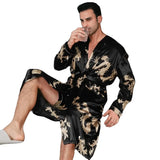 Man wearing a black silk robe with gold dragon embroidery holding a drink