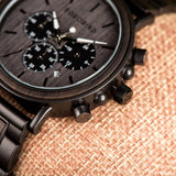 Close-up of dark wood watch showing grey chronograph dial and sub-dials