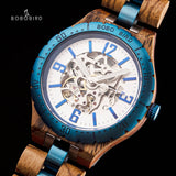 Wooden skeleton watch with blue bezel and white dial on a natural wood strap