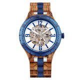 Wooden skeleton watch with blue bezel and white dial on a white background