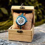 Wooden couples watch displayed in a wooden gift box in a natural outdoor setting