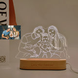 Clear acrylic panel etched with a couple portrait, unlit on a wooden base