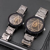 Matching black and silver watches with geometric compass style dials and steel bracelets