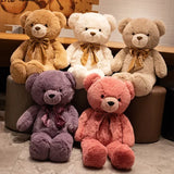 Giant teddy bears in cream, tan, purple and pink with satin bow ties