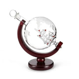 Etched globe spirit decanter on curved wood stand on white background