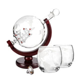 Globe decanter with wood stand and two etched map tumblers on white background