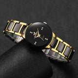 Two gold and black rhinestone watches displayed together on a dark background